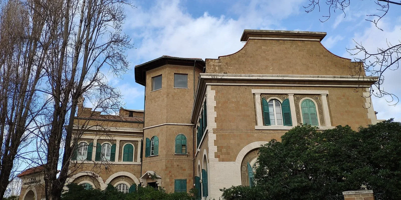 Il Palazzo del Governatorato di Ostia in tufo e travertino, con torre e finestre ad arco, oggi sede del Municipio X